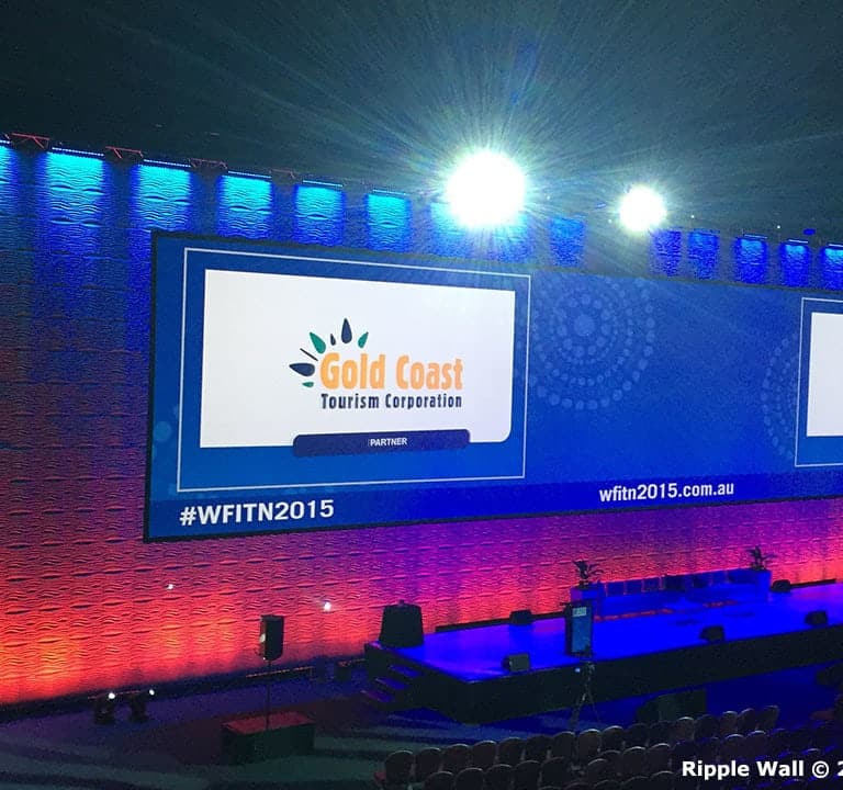 A stage setup with large screens displaying 